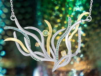 A silver and gold necklace made to resemble seagrass with diamonds embedded 