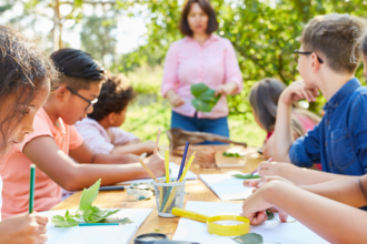 children in group outside studying nature