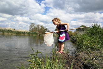 Child river dipping © Amy Ellis