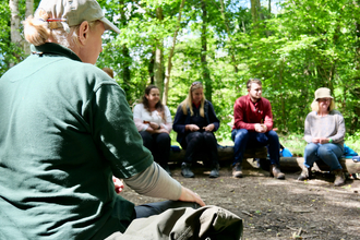 Hampshire & isle of wight wildlife trust staff delivering forest school training to a group of teachers and leaders