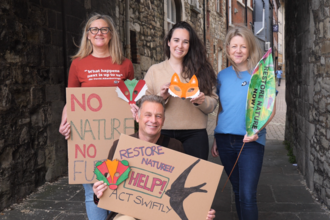 Trust CEO Debbie Tann MBE, Trust President Megan McCubbin, Director of Advocacy and Engagement Hannah Terrey, Trust Vice President Chris Packham - holding banners and masks for the Restore Nature Now Rally