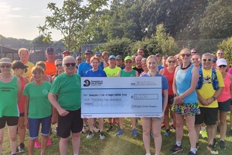 Stubbington Green runners presenting a large cheque of £4000