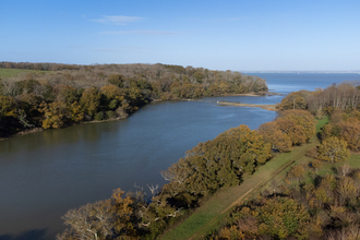 Aerial view of a river mouth with woodland either side