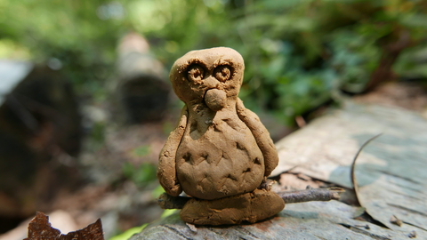 Clay owl sitting on a log made at Swanwick Lakes Wildlife Rangers