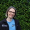 Hampshire & Isle of Wight Wildlife Trust female staff member smiling in front of a green background 