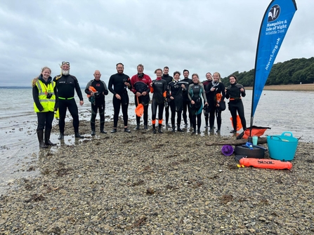 Trust staff and volunteers in a group photo after seagrass seed harvesting.