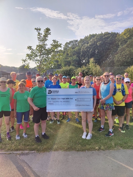 Stubbington Green runners presenting a large cheque of £4000