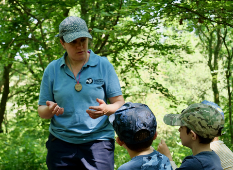 Swanwick school visit - backs of two children with Education Officer teaching 